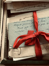 Briefstapel, der von einem roten Band zusammengehalten wird