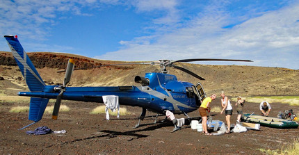 Scientists in front of helicopter during field work in Suguta Valley, N Kenia