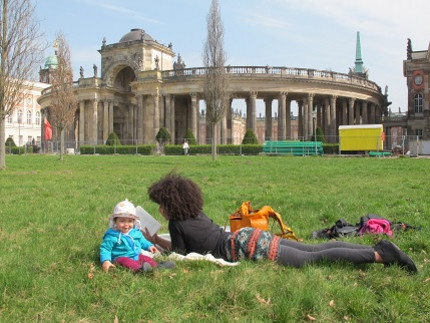 student with small child at university campus "Am Neuen Palais"