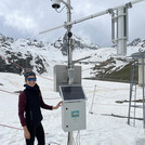 Field site Weisssee: a scientist standing next to a newly installed CRNS sensor in an alpine landscape with snow | Photo: Cosmic Sense Consortium