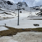 Field site Dresdner Hütte: Montane landscape with patchy snow pattern. In the landscape is measuring equipment, a ski lift and a scientist with a tripod | Photo: Cosmic Sense Consortium