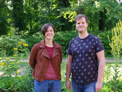 people standing in front of flowers and trees