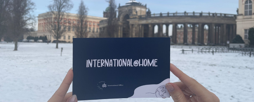 International@Home Postkarte vor schneebedeckten Kolonaden