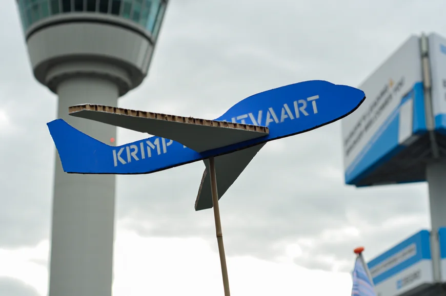 A cardboard blue plane with the phrase 'shrink air transport'