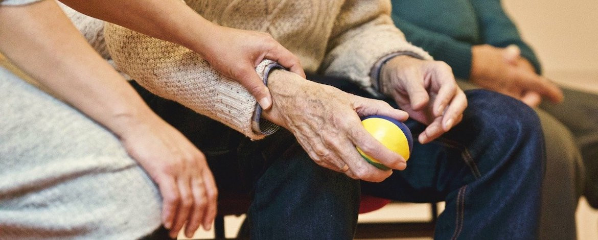 Elderly people passing a ball with a younger carer - LangAge Corpora
