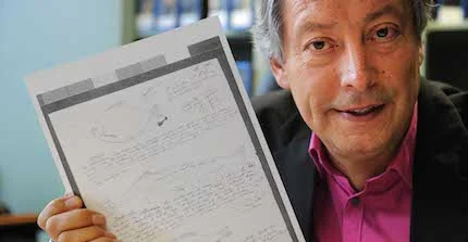 Photo of Ottmar Ette with a facsimile of a journal page