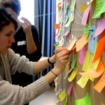 Participant in front of colorful post tips