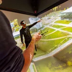 This image shows two people who are looking at a landscape projected on to a wall in the 3D Laboratory.