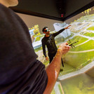 This image shows two people who are looking at a landscape projected on to a wall in the 3D Laboratory.