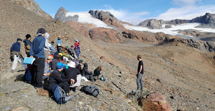 Presenting in the field at unique places: A student presentation about the "Energy and water budget of glaciers" in front of the Vernagt glacier on 2.800 asl.