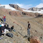 Presenting in the field at unique places: A student presentation about the "Energy and water budget of glaciers" in front of the Vernagt glacier on 2.800 asl.