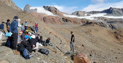 Presenting in the field at unique places: A student presentation about the "Energy and water budget of glaciers" in front of the Vernagt glacier on 2.800 asl.