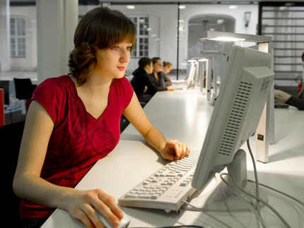Eine junge Frau schaut auf einem Computer. Foto: Karla Fritze