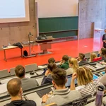 This image shows students in a full lecture hall. 