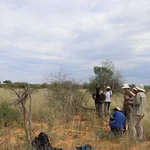 NamTip researchers standing in front of a demarked plot of savanna grassland with measuring devices