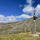 Field site Hohe Mut: Steel tower with measuing equipment on a alpine pasture with bare mountains in the background | Photo: Cosmic Sense Consortium