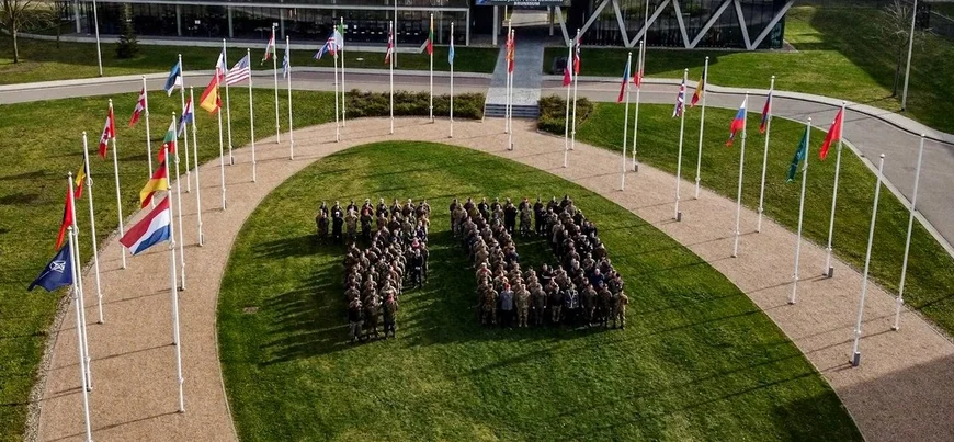 NATO turned 70 in 2025. Uniformed personnel form the number 70 on the lawn in front of the flags of NATO members.