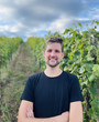 a man is standing in the landscape, in front of plants