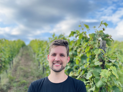 a man is standing in the landscape, in front of plants