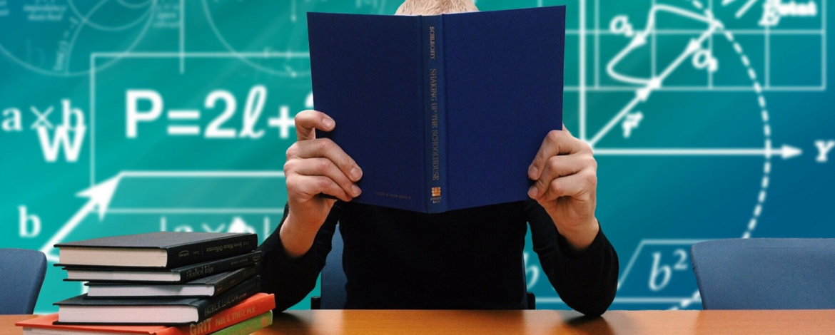 Doctoral student sitting behind a book - Doctorates