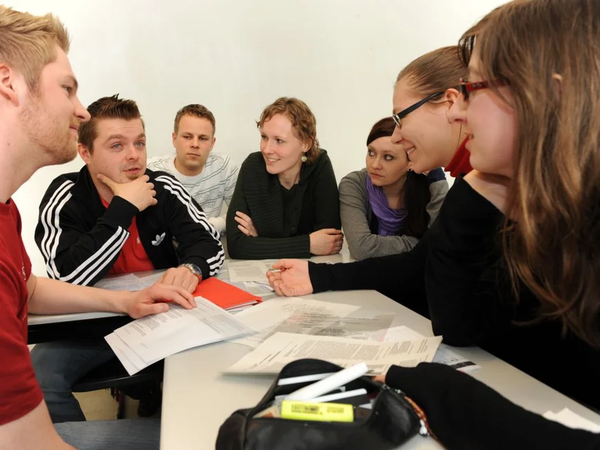 Students sitting in class and discussing