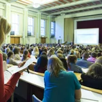 This image shows students in a full lecture hall. 