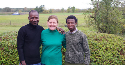 people standing in front of grassland