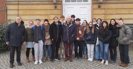 Group of pupils from Adolf Reichwein Grammar School in Heusenstamm together with their teacher (far left) and former Brigadier General Dr Wittmann (centre)