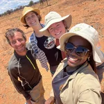 Selfie of smiling NamTip researchers with savanna rangeland in the background