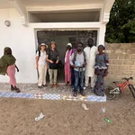 Part of the DakE team standing in front of the house of a local school’s teacher, where we installed one sensor.