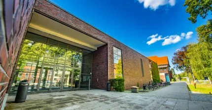 Large entrance portal of a building made of red clinker bricks