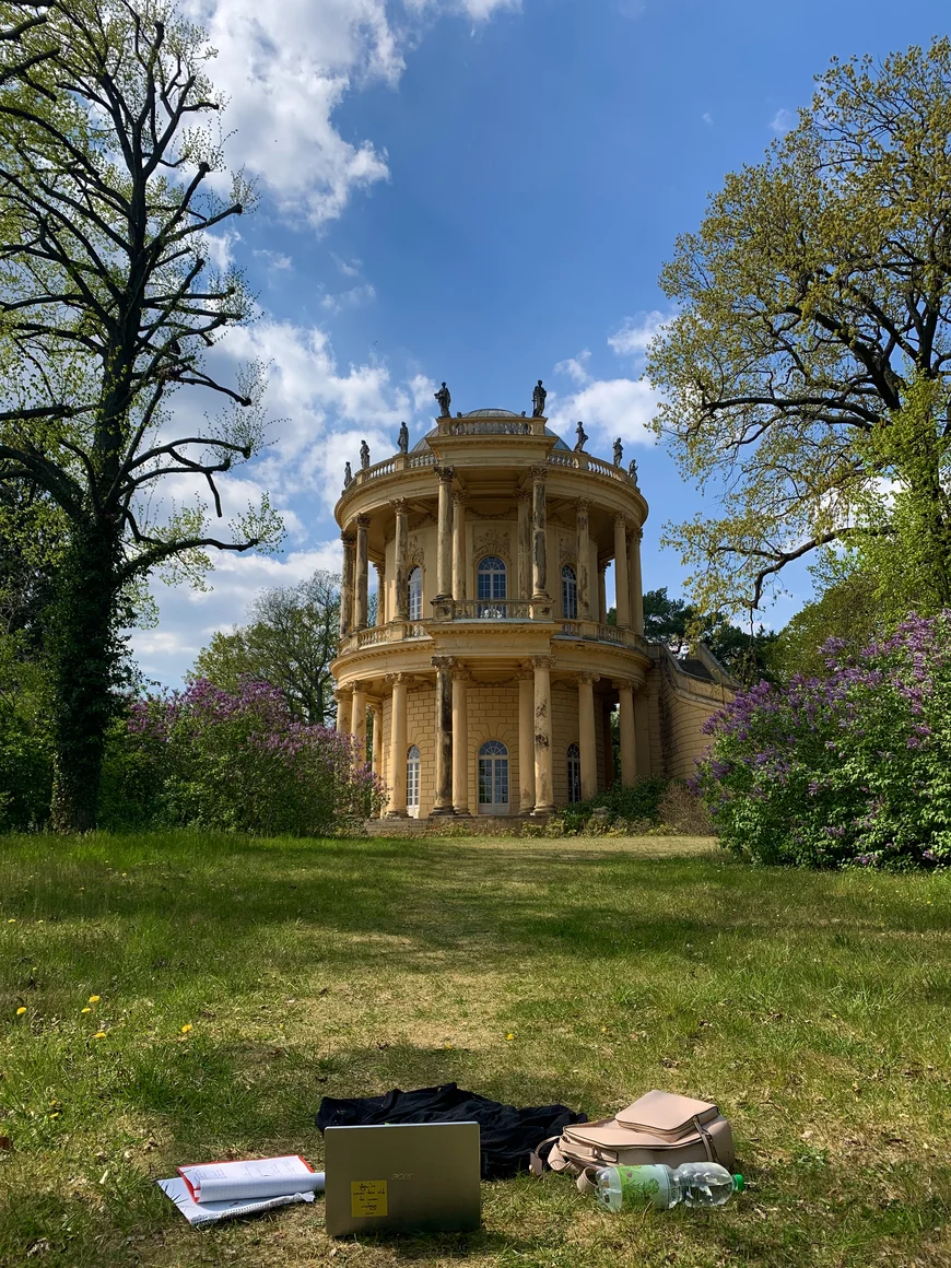 Laptop und Rucksack auf Wiese mit Blick auf den Belverdere Im Park Sanoucci