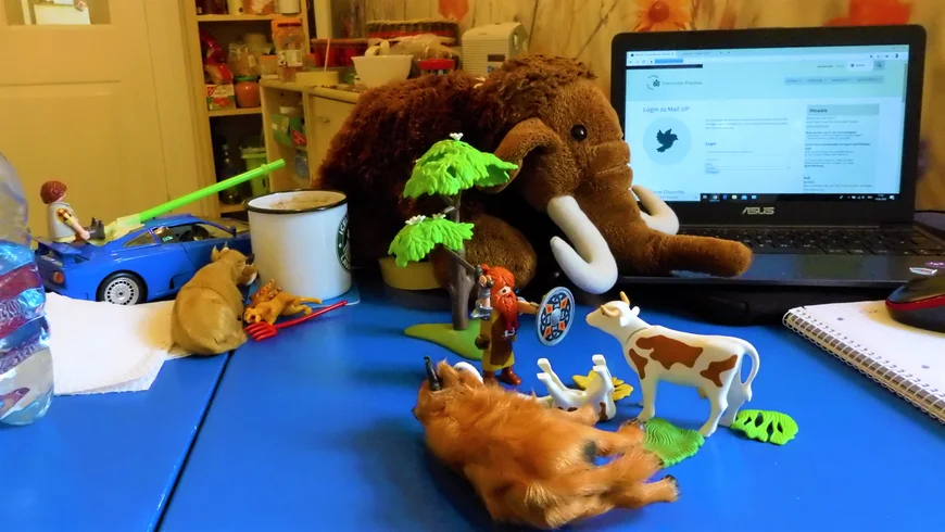 Tisch mit Spielzeug darauf und Laptop