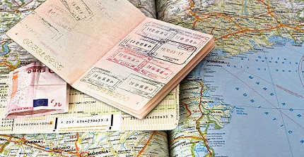 passport with visa stamps on a world map