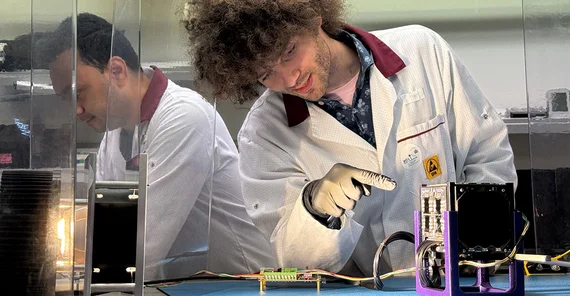 Felix Lang points to CyBEEsat’s primary payload: perovskite solar cells.