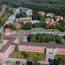 Aerial drone image of the Griebnitzsee campus with several research buildings and a student village