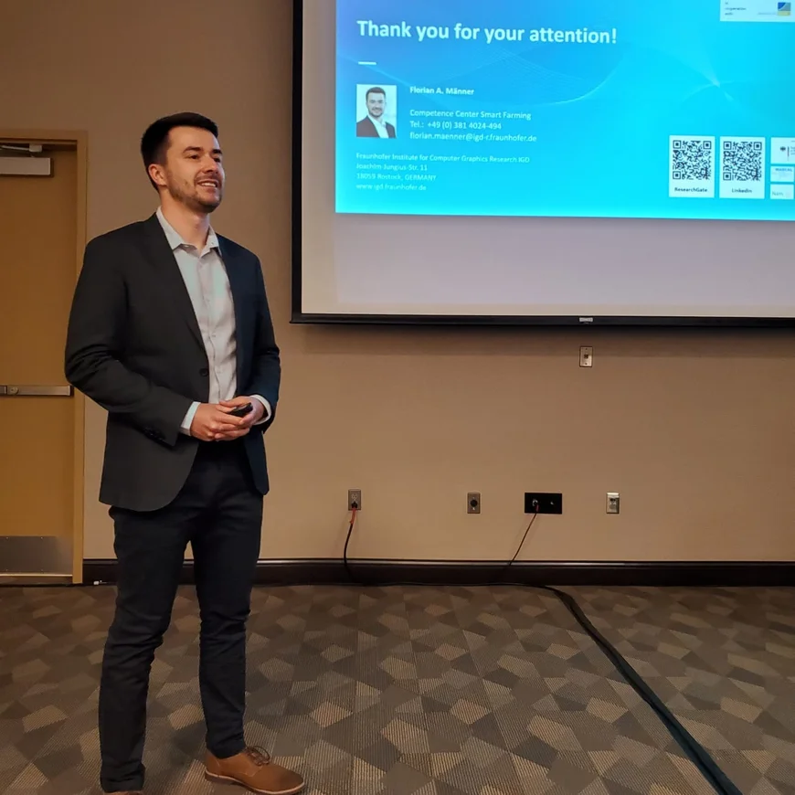 A man is standing in front of a presentation.