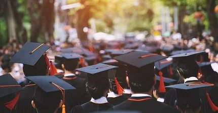 students with graduation hats