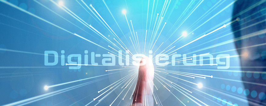 A finger taps on the word “digitalization,” from which stylized rays emanate in all directions