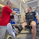 This image shows two people during an examination in the sports sciences department.