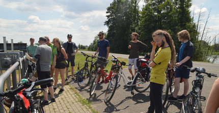Bicycle Tour. At the Odra river, the group listening to Hubert Wiggerings explanations