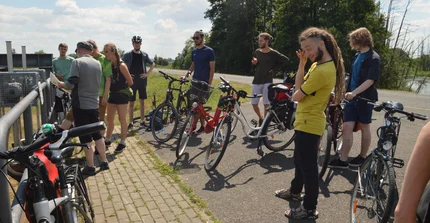 Bicycle Tour. At the Odra river, the group listening to Hubert Wiggerings explanations