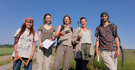 a group of people standing in front of a field