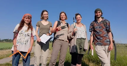 a group of people standing in front of a field