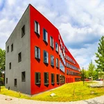 A red building that has an undulating curved facade