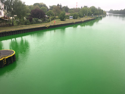 Uranine tracer in river water shortly after entering the tracer