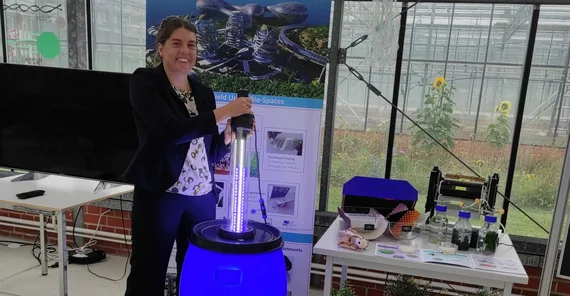 Dr. Anna Fricke with a “lightsaber” at the algae tank.