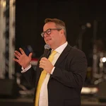 Ein Mann im Anzug mit Mikrofon