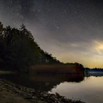 Stars and comet over the lake.