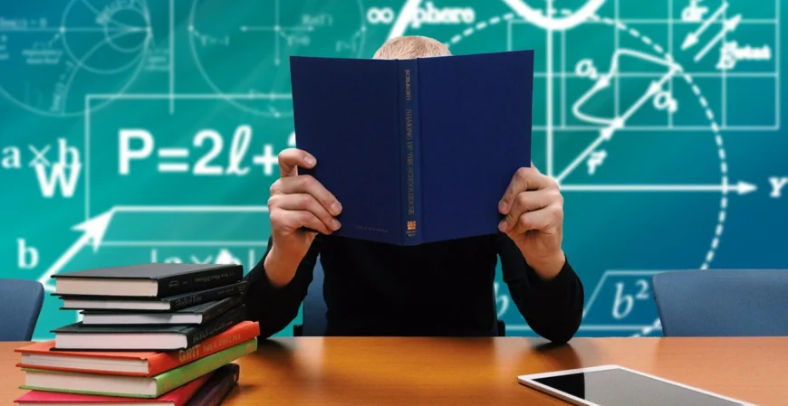 PhD Student hiding behind a book